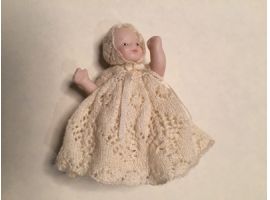 Baby in christening dress lace knitted