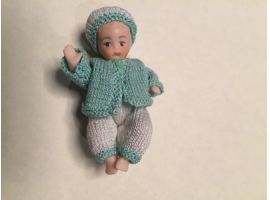 Porcelain  boy in outdoor knitted outfit
