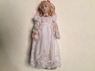 Porcelain girl with white coton dress and lace