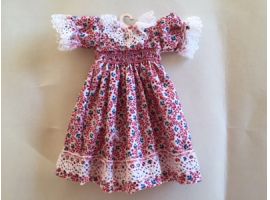 Embroidered smocked dress on hanger