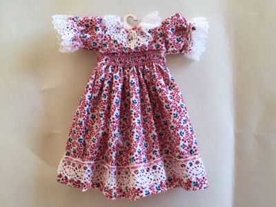 Embroidered smocked dress on hanger