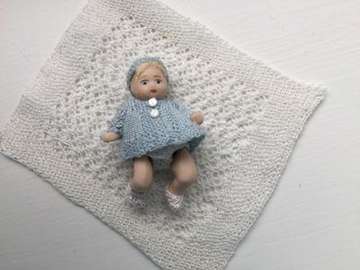 Baby boy and knitted outfit